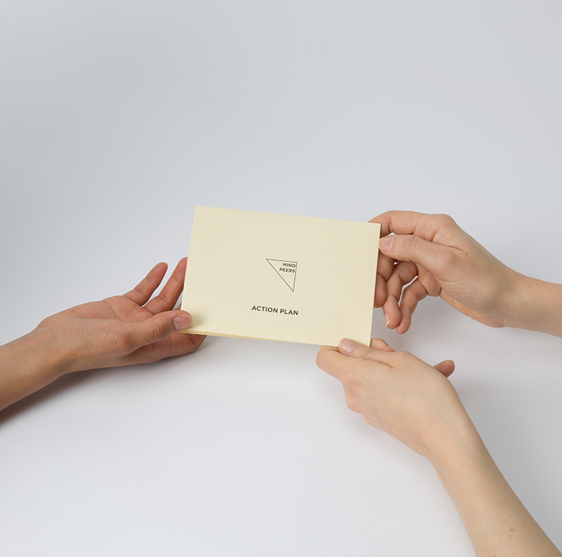 Two hands exchanging the Mind Peers action plan card
